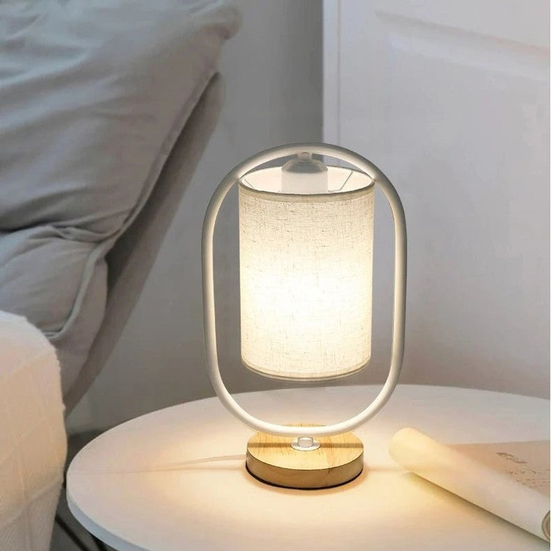 Bordslampa med cylindrisk skärm och oval ram