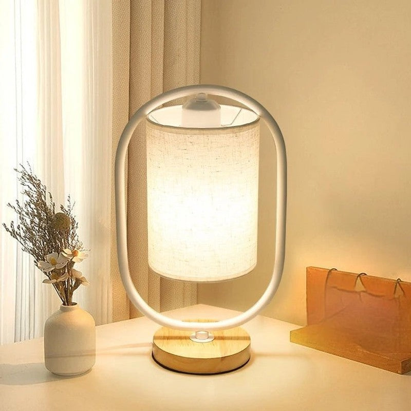 Bordslampa med cylindrisk skärm och oval ram