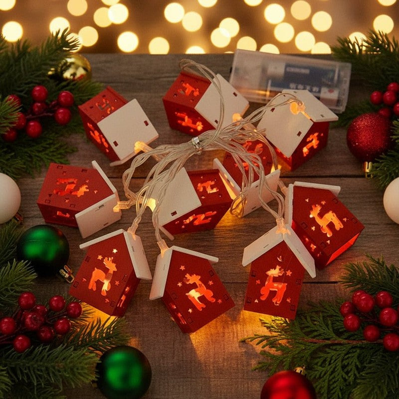 Juldekoration med LED-ljuskedja och små husformade lyktor